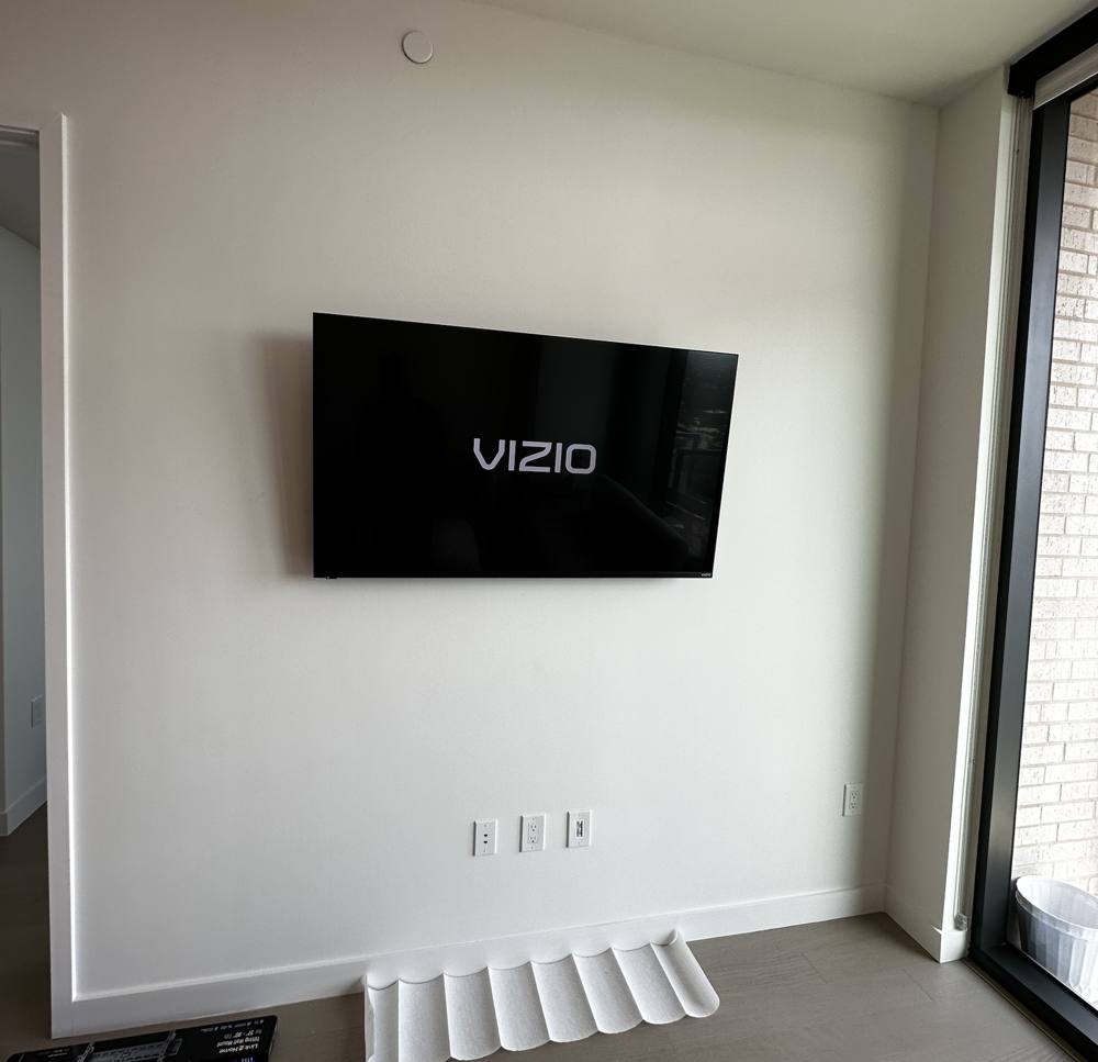 Vizio TV centered on a bedroom wall